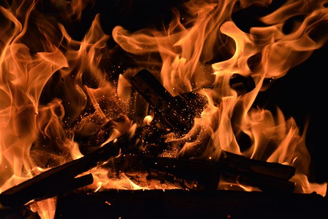 Close-Up of Campfire Flames and Burning Wood in Darkness - Download Free Stock Photos Pikwizard.com