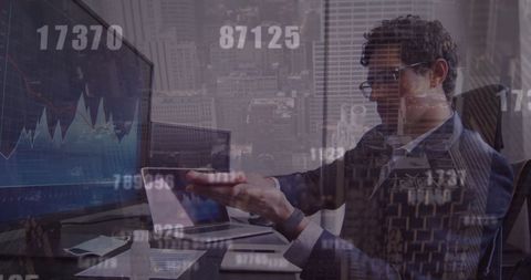 Businessman disinfecting hands in data-driven office environment