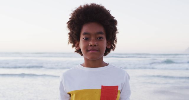 Portrait of african american boy smiling while standing at the beach - Download Free Stock Photos Pikwizard.com