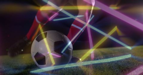 Caucasian Football Player Kicking Ball with Neon Effects