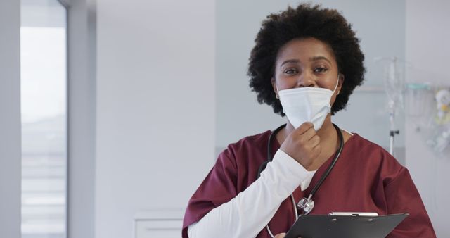 Smiling Nurse Adjusting Face Mask in Hospital Setting - Download Free Stock Images Pikwizard.com