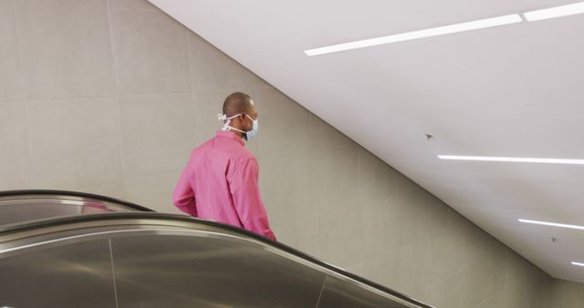 Man with Face Mask on Escalator in Modern Building - Download Free Stock Images Pikwizard.com