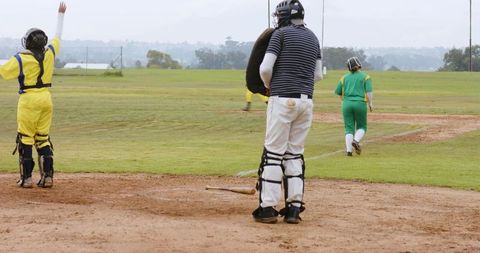 Diverse Softball Players Cheering Outdoors with Vibrant Athletic Gear