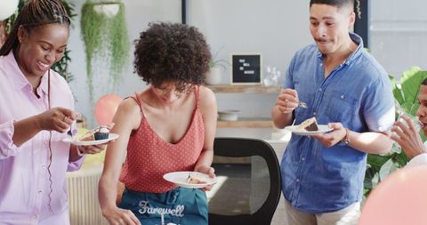 Office Celebration with Colleagues Enjoying Cake and Socializing