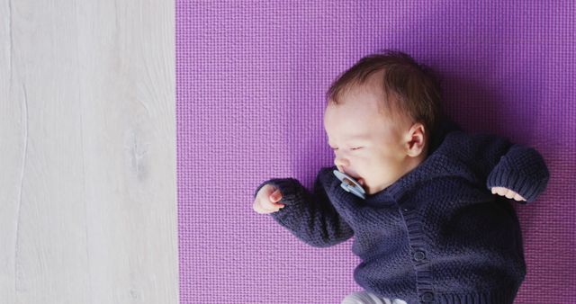 Image of caucasian newborn baby sleeping on violet blanket. newborn, infant, childhood and motherhood concept digitally generated image.