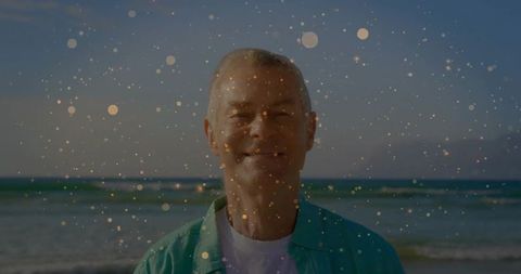 Senior man enjoying tranquil beach with dreamy bokeh effect