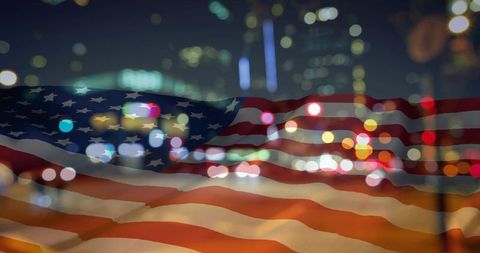 Waving translucent american flag overlaying neon urban night skyline with bokeh lights