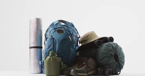 Camping gear with backpack and rucksack on white background