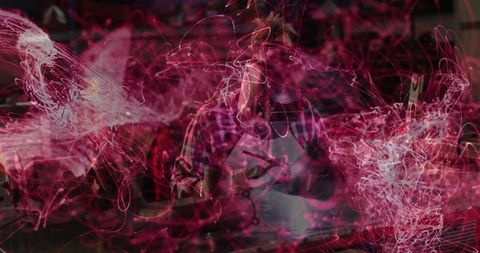 Metalworker Using Tools in Workshop Amidst Dynamic Light Trails