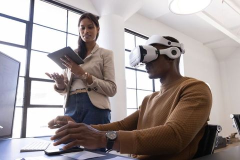 Innovative Coworkers Collaborating with VR Headset in Modern Office