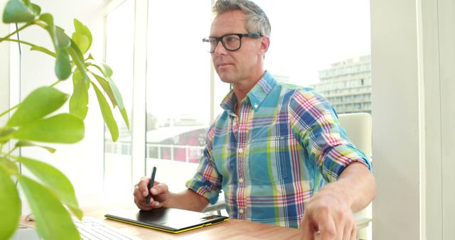 Senior Graphic Designer at Desk, Focused on Digital Art Table - Download Free Stock Images Pikwizard.com