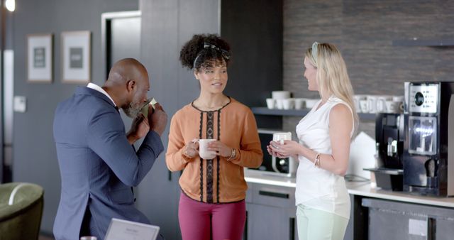 Diverse professional group enjoying coffee break in modern office kitchen - Download Free Stock Images Pikwizard.com