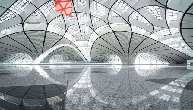 Showcasing fan-shaped columns reflecting on terrazzo floor in futuristic airport terminal
