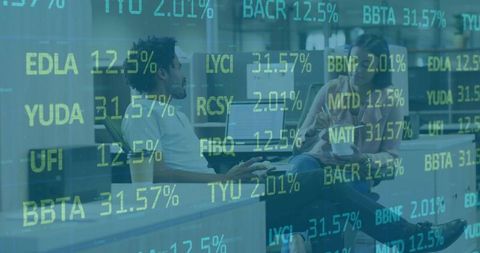 Analyzing stock data on laptop in relaxed office setting