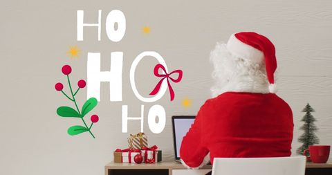 Santa Claus Working on Laptop with Christmas Decorations