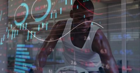 Intense indoor cycling workout overlaid with financial market charts and data visualization