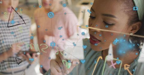Businesswoman Analyzing Data on Transparent Board in Office