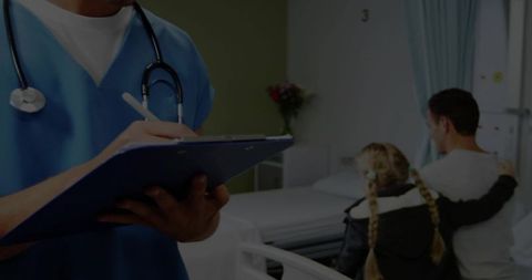 Healthcare Professional Recording Patient Information in Hospital