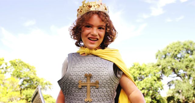 Happy Child in Knight Armor with Crown Smiling Outdoors - Download Free Stock Images Pikwizard.com