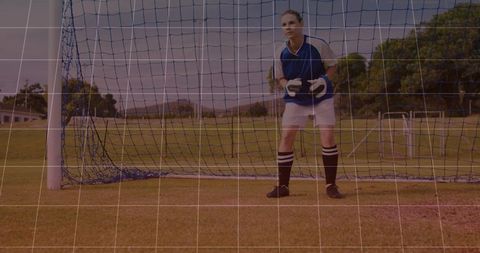 Female Soccer Goalkeeper Standing Ready in Goal Wearing Navy Jersey and Gloves