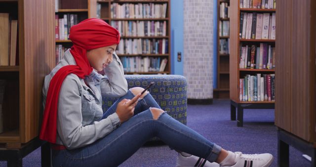 Young Woman in Red Hijab Using Smartphone in Library - Download Free Stock Images Pikwizard.com