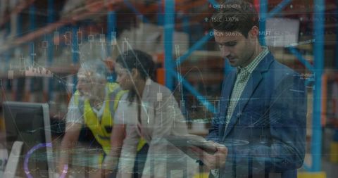 Warehouse Supervisors Analyzing Data with Technology Integration