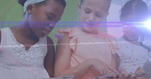 Young Schoolchildren Engaging with Digital Learning Tablets