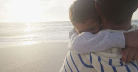 Father and Son Embrace at Serene Beach Sunset