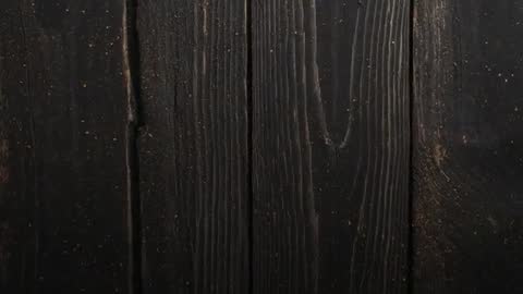Studio Closeup Showing Dark Wooden Planks Grain and Dust Particles, Rustic Texture Loop