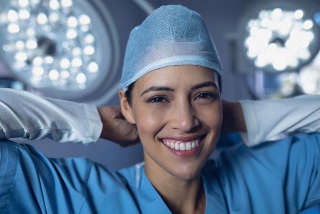 Portrait of female surgeon wearing surgical cap in operation room at hospital