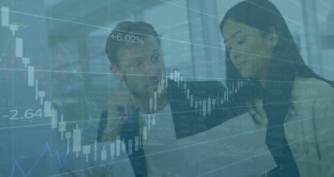 Business Professionals Analyzing Financial Charts in Modern Workspace