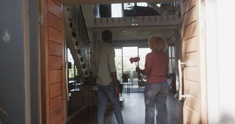 Couple entering modern home embracing lifestyle and love