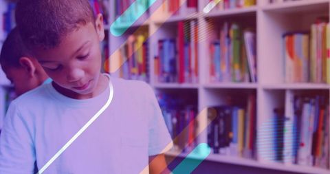 Young boy reading in colorful school library with modern geometric overlays