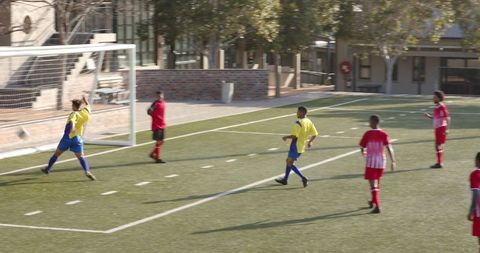 Youth soccer team celebrates exciting goal on field