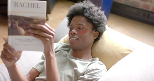 Young Man Relaxing and Reading a Book at Home - Download Free Stock Images Pikwizard.com