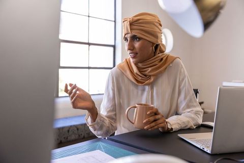 Creative Entrepreneur Engaged in Design Discussion at Modern Workspace