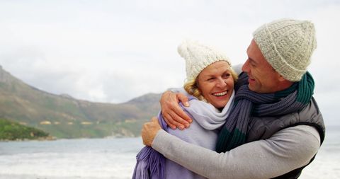 Happy Middle-Aged Couple Embracing by Scenic Seaside