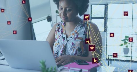 african american woman using laptop with digital icons overlay - Download Free Stock Images Pikwizard.com