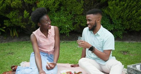 African Couple Enjoying Outdoor Picnic with Refreshing Drinks