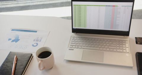 Color-coded Spreadsheet on Laptop in Minimalist Workspace