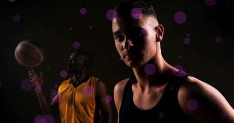 Diverse basketball players with dynamic lighting in action