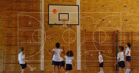 School children playing basketball in gym reaching for hoop with tactics diagram overlay
