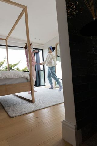 Teen friends enjoying skincare night in minimal modern bedroom with balcony view