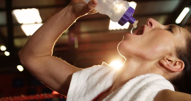 Female athlete drinking water from sports bottle during workout - Download Free Stock Images Pikwizard.com