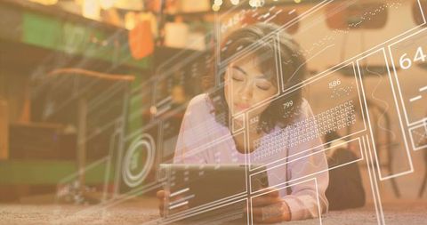 Woman Relaxing on Floor With Tablet in Digital Interface Projection