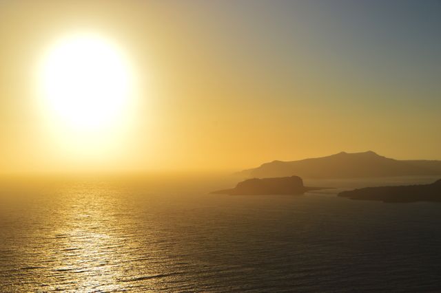 Sunset over Ocean with Distant Mountains and Clear Sky - Download Free Stock Photos Pikwizard.com