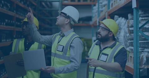 Team of engineers conducting equipment inspection in warehouse