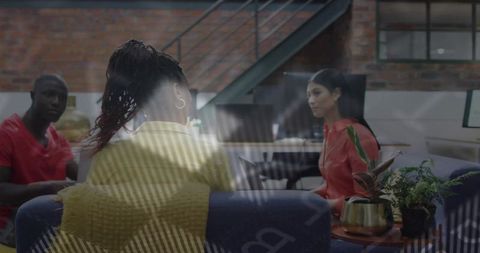 Colleagues Collaborating in Modern Industrial Loft Lounge with Glass Reflection