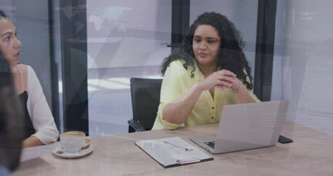 Diverse Women Analyzing Financial Data with Laptop