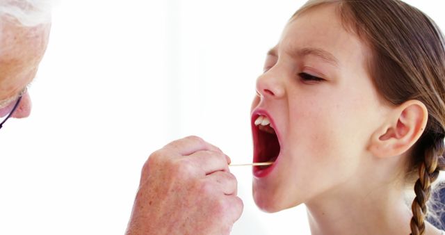 Doctor Examining Child's Throat During Medical Checkup - Download Free Stock Images Pikwizard.com